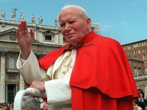 Pope John Paul II waves to the crowd in St. Peter's Square at the Vatican on April 23, 1997 (Credit: Associated Press/Andrew Medichini)
