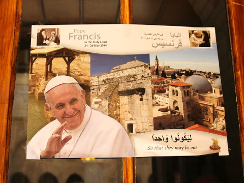 A poster advertising the upcoming visit of Pope Francis I to the Holy Land is displayed in a window to the entrance of the Church of Saint Catherine, which is attached to the Church of the Nativity in Bethlehem, May 10, 2014 (Credit: Brittany Kulick)