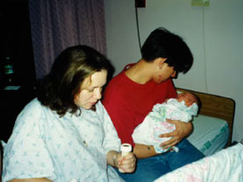 Rick Zarate holds his newborn daughter while sitting beside his girlfriend, and Belle's mother, Cindy, in their hospital room soon after Belle's birth (Credit: Rick Zarate via BraveLove)