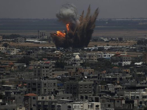 Smoke and flames are seen following what police said was an Israeli air strike in Rafah in the southern Gaza Strip July 8, 2014 (Credit: Reuters/Ibraheem Abu Mustafa)
