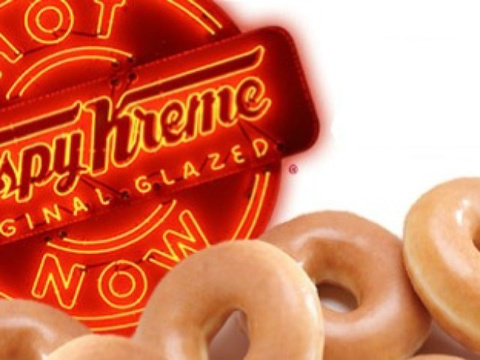 Krispy Kreme concept design with donuts in the foreground and the famous Krispy Kreme 'Hot Now' neon sign in the background (Credit: Krispy Kreme via Instagram)