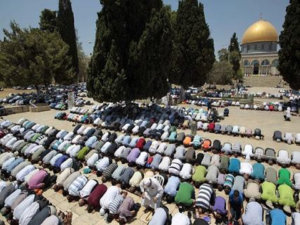 Palestinian men pray in front the Dome of the Rock on the compound known to Muslims as Noble Sanctuary and to Jews as Temple Mount in Jerusalem's Old City on the first Friday of the holy month of Ramadan July 20, 2012 (Credit: Reuters/Ammar Awad)