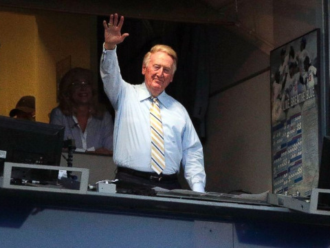 Broadcaster Vin Scully acknowledges the crowd at Dodger Stadium during a baseball game between the Los Angeles Dodgers and the Atlanta Braves, July 29, 2014, in Los Angeles (Credit: AP/Jae C. Hong)