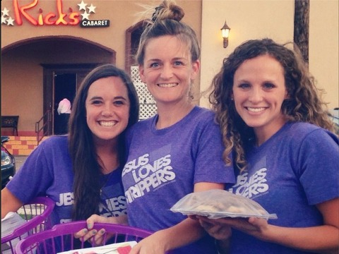 Jesus Said Love volunteers pose for a photo with care packages for dancers outside a San Antonio night club (Credit: Jesus Said Love via Instagram)