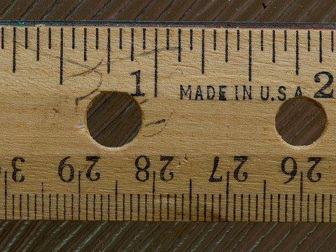 A closeup of a wooden ruler showing both imperial (inches) and metric (centimeters) forms of measurement(Credit: Biking Nikon SFO via Flickr)