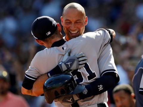New York Yankees shortstop Derek Jeter (2) is congratulated by right fielder Ichiro Suzuki (31) after being replaced by a pinch runner during the third inning at Fenway Park on September 28, 2014, Boston, MA, USA (Credit: USA TODAY Sports/Greg M. Cooper)