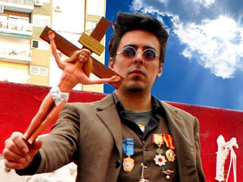 Emiliano Paolini holds a Ken doll as Jesus Christ nailed to a cross (Credit: Pool Paolini via Facebook)