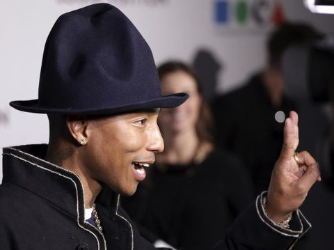 Singer Pharrell Williams gestures as he attends the Museum of Contemporary Art (MOCA)'s 35th Anniversary Gala presented by Louis Vuitton at The Geffen Contemporary at MOCA in Los Angeles, California, on March 29, 2014 (Credit: Reuters/Jonathan Alcorn)