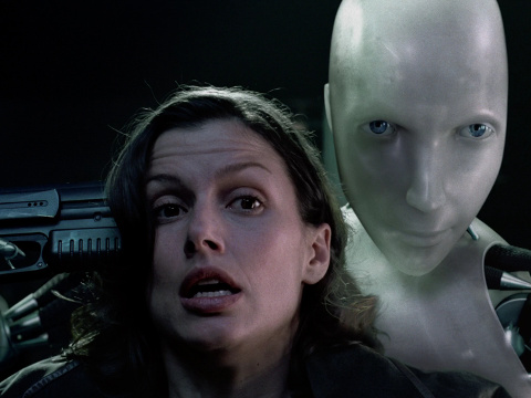 Bridget Moynahan, in a scene from the Twentieth Century Fox movie I, Robot, where her character robopsychologist Susan Calvin is taken hostage by the robot named Sonny (Credit: Twentieth Century Fox)