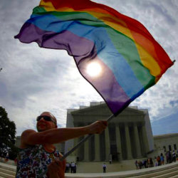 Gay marriage supporter Vin Testa waves a rainbow flag in front of the U.S. Supreme Court in Washington, June 24, 2013 (Credit: Reuters/Jonathan Ernst)