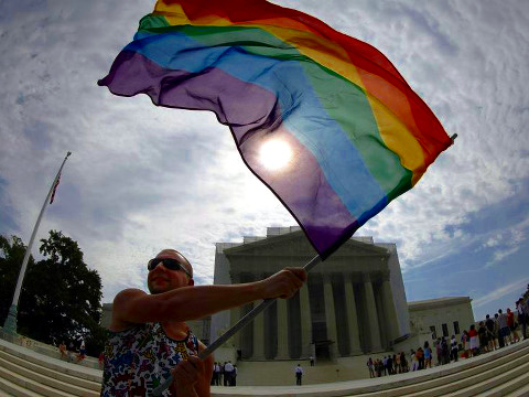 Gay marriage supporter Vin Testa waves a rainbow flag in front of the U.S. Supreme Court in Washington, June 24, 2013 (Credit: Reuters/Jonathan Ernst)