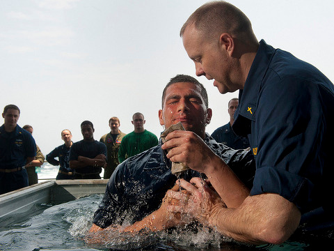 Navy chaplain aboard the Nimitz-class aircraft carrier USS Carl Vinson (CVN 70) baptizes an while on patrol in the US 7th Fleet area of responsibility, Arabian Sea, May 8, 2011 (Credit: US Navy/Mass Communication Specialist 2nd Class James R. Evans via Flickr)