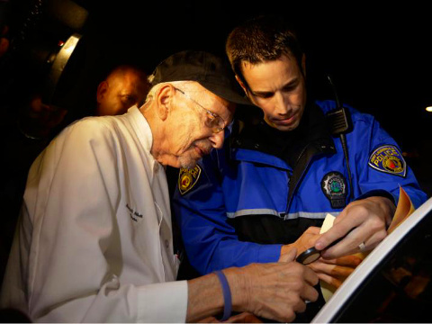Homeless advocate Arnold Abbott, 90, of the nonprofit group Love Thy Neighbor Inc is fingerprinted by a Fort Lauderdale police officer, Wednesday, November 5, 2014, in Fort Lauderdale, Florida (Credit: AP/Lynne Sladky)