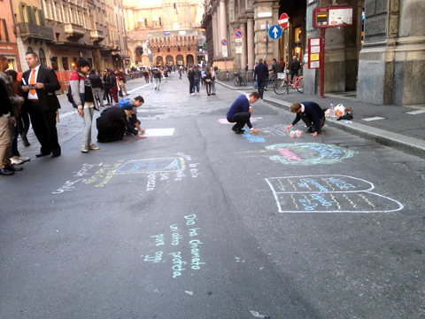 Morman missionaries use chalk to create drawings and texts on the streets of Via Rizzoli and Via Calzolerie in Bologna, Italy, to spread the teachings of the Church of Jesus Christ of Latter-day Saints, November 11, 2014 (Credit: Menachem Wecker)