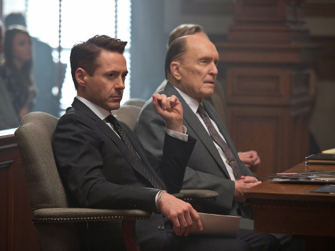 Robert Downey Jr as big city lawyer Hank Palmer, who returns to his childhood home to defend his estranged father Judge Joseph Palmer, played by Oscar winner Robert Duvall, starring with Duvall for the first time in a courtroom scene from the new Warner Brothers movie The Judge (Credit: Warner Brothers Pictures)