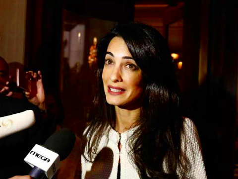 Amal Clooney speaks to the media inside a central Athens hotel, along with Geoffrey Robertson, head of Doughty Street Chambers, and David Hill , head of the International Committee for the Reunification of the Parthenon Marbles, in advance of her meeting with Greek Culture Minister Kostas Tassoulas to discuss plans to return of the Parthenon Marbles, October 13, 2014 (Credit: Reuters/Yorgos Karahalis)