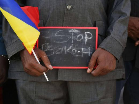 A man holds a sign that reads 'Stop Boko Haram' at a rally to support Chadian troops heading to Cameroon to fight Boko Haram, in Ndjamena January 17, 2015 (Credit: Reuters/Emmanuel Braun)