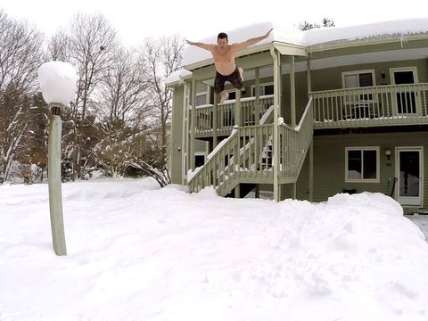 Thrill-seeking residents in Boston are taking to social media with videos of them jumping out of windows into massive snow drifts. In this video, Jeffery Bruno jumps from a stair railing into a 4 foot pile of snow (Credit: Jeffery Bruno via YouTube)