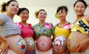 Pregnant women show off images on their stomachs, painted by an artist during a contest at a hospital in Haikou, in the Hainan Province, South China, August 07, 2006 (Credit: Reuters/ChinaFotoPress/Huang Yibing)