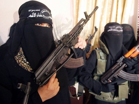 Female members of ISIS, part of the ISIL Takfiri militant group, wearing full battle gear over their veiled clothing (Credit: Reuters/Tabatha Kinder)
