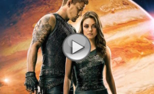 Mila Kunis as down-on-her-luck cleaning woman Jupiter Jones and Channing Tatum as Caine Wise, an interplanetary warrior, standing together with the planet Jupiter in the background from the official theatrical poster for the space opera movie from Warner Brothers (Credit: Warner Brothers Pictures)