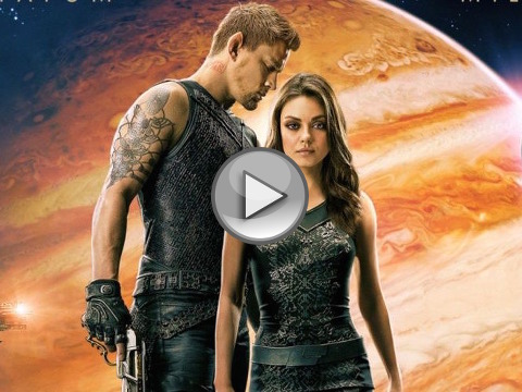 Mila Kunis as down-on-her-luck cleaning woman Jupiter Jones and Channing Tatum as Caine Wise, an interplanetary warrior, standing together with the planet Jupiter in the background from the official theatrical poster for the space opera movie from Warner Brothers (Credit: Warner Brothers Pictures)