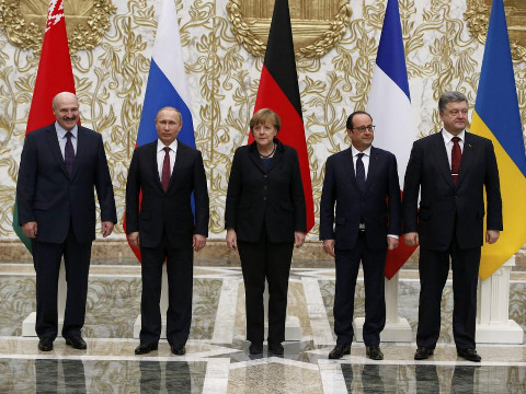 Belarus' President Alexander Lukashenko (L), Russia's President Vladimir Putin (2nd L), Ukraine's President Petro Poroshenko (R), Germany's Chancellor Angela Merkel (C) and France's President Francois Hollande pose for a family photo during peace talks in Minsk, February 11, 2015 (Credit: Reuters/Grigory Dukor)