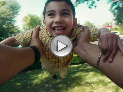 A father plays with his son, swinging him around in a circle, in a screen grab from new 2015 #RealStrength campaign from Dove Men Care (Credit: Dove Men Care US via Youtube)