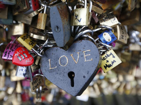 Thousands of padlocks clipped by lovers are seen on the fence of the Pont des Arts over the River Seine in Paris February 13, 2014 on the eve of Valentine's Day (Credit: Reuters/Charles Platiau)