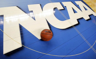 A basketball sits on the NCAA logo at center court of the basaketball floor of the Greensboro Coliseum Complex during the second round of the 2012 NCAA men's basketball tournament, March 16, 2012 (Credit: USA Today/Bob Donnan)