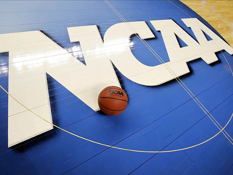 A basketball sits on the NCAA logo at center court of the basaketball floor of the Greensboro Coliseum Complex during the second round of the 2012 NCAA men's basketball tournament, March 16, 2012 (Credit: USA Today/Bob Donnan)