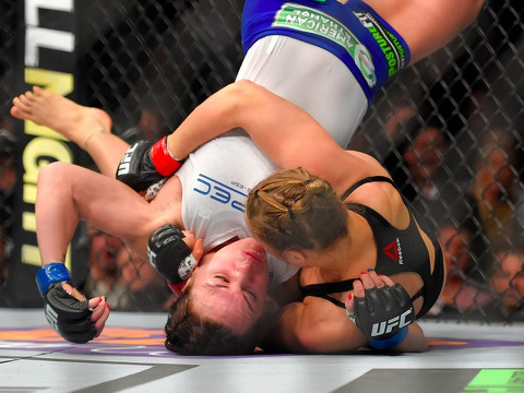 Ronda Rousey, right, grapples with Cat Zingano, defeating her in 15 seconds in a UFC 184 mixed martial arts bantamweight title bout, Saturday, February 28, 2015, in Los Angeles (Credit: AP/Mark J. Terrill)