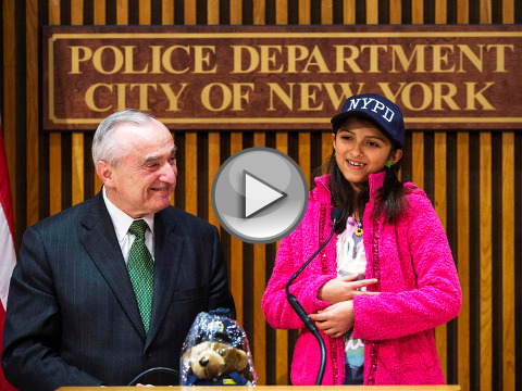Police Commissioner Bill Bratton presents teddy bear and chocolates to NYPD fan Savannah Solis, the Texas 10-year-old who sent police more than 200 thank-you cards after the slayings of two officers in December, Wednesday, February 25, 2015 (Credit: New York Daily News/Susan Watts)