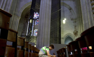 A man sits in the pews of Cathedral of St. John the Divine in New York, June 25, 2013 (Credit: Reuters/Carlo Allegri)