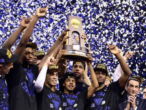 Duke Blue Devils guard Quinn Cook (middle) and teammates hoist the NCAA championship trophy after defeating the Wisconsin Badgers in the 2015 NCAA Men's Division I Championship game at Lucas Oil Stadium, April 6, 2015 (Credit: USA TODAY Sports/Bob Donnan)