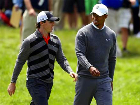 Tiger Woods (R) of the U.S. speaks with playing partner Rory McIlroy of Northern Ireland as they walk on the 15th hole during the second round of the 2013 U.S. Open golf championship at the Merion Golf Club in Ardmore, Pennsylvania (Credit: Reuters/Adam Hunger)
