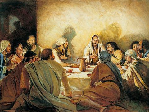 A depiction of Luke 22:14-23, illustrating the Last Supper with Christ in the center, surrounded by eleven apostles, each reacting differently to His words, while the shadow of the departing Judas is seen in the background (Credit: Walter Rane)