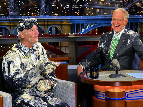 David Letterman laughs while Bill Murray speaks after jumping out of a cake during one of the final shows in the final week of The Late Show with David Letterman, May 19, 2015 (Credit: CBS/John Paul Filo)