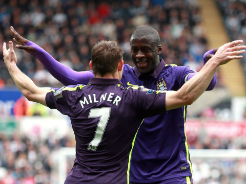 Yaya Toure (R), a forward for Manchester City in the English Premier League, celebrates with teammate James Milner (L) after scoring his first of two goals against Swansea City at The Liberty Stadium, May 17, 2015 (Credit: PA Wire)