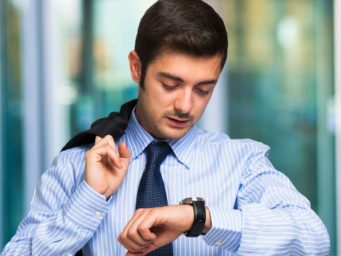 Businessman checking time on his watch (Credit: Minerva Studios via Fotolia)