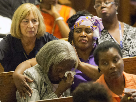 Parishioners comfort one another during a memorial service at Morris Brown AME Church for the people killed Wednesday during a prayer meeting inside the historic black church in Charleston, South Carolina, June 18, 2015 (Credit: AP/David Goldman)