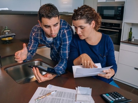 Couple reviewing their accounts with a digital tablet (Credit: doble.d via Fotolia)