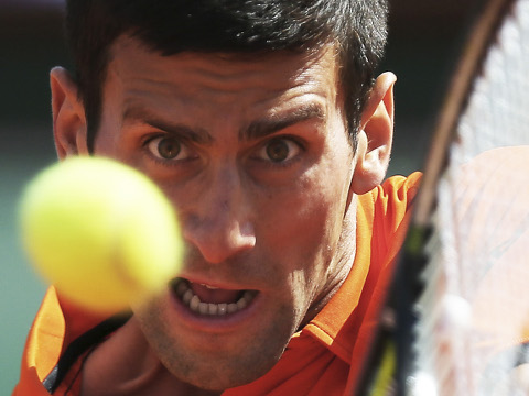 Serbia's Novak Djokovic returns in the quarterfinal match of the French Open tennis tournament against Spain's Rafael Nadal at the Roland Garros stadium, in Paris, France, Wednesday, June 3, 2015 (Credit: AP Photo/David Vincent)