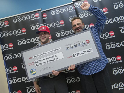 Anthony Perosi (R) and son Anthony Perosi III (L) pose for a photo holding a check for the $136 million Powerball jackpot picked March 14, which they will split, June 4, 2015 (Credit: New York Daily News/Joe Marino)