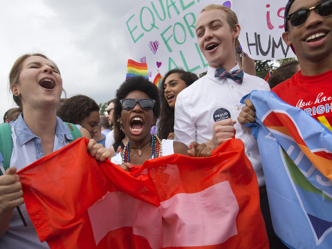 From left, Annie Katz of the University of Michigan, Zaria Cummings of Michigan State University, Spencer Perry of Berkeley, Calif., and Justin Maffett of Dartmouth University, celebrate outside of the Supreme Court in Washington, Friday June 26, 2015, after the court declared that same-sex couples have a right to marry anywhere in the US. (Credit: AP Photo/Jacquelyn Martin)