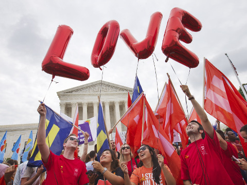 Same-sex marriage supporters hold up balloons that spell the word 'love' as they wait outside of the Supreme Court in Washington before the court declared that same-sex couples have a right to marry anywhere in the US, June 26, 2015 (Credit: AP Photo/Jacquelyn Martin)