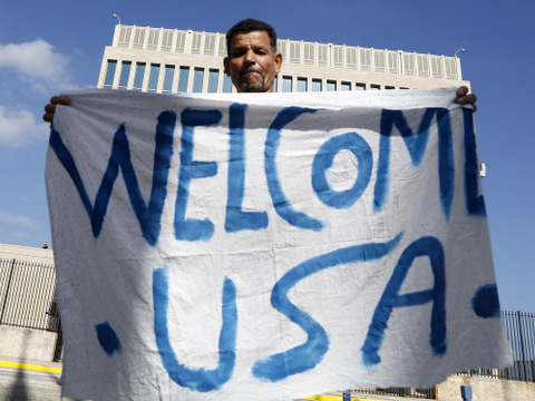 Cuban Lazaro Cudilleiro holds a banner in front of the United States Embassy in Havana, Cuba, July 20, 2015 (Credit: AP Photo/Desmond Boylan)