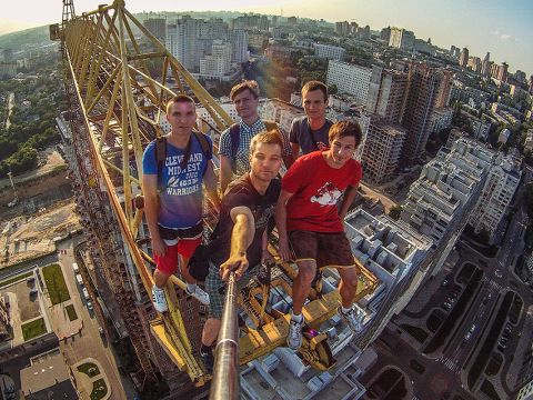 Yaroslav Segeda takes a selfie of himself and friends on top of a crane in Kiev Extreme urban climbers take 'selfies' on top of tall buildings, Kiev, Ukraine, April 2015 (Credit: Rex Features via AP Images)