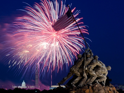 Independence Day celebration fireworks are seen from the Iwo Jima, U.S. Marine Corps Memorial at the entrance of Arlington National Cemetery, with the Lincoln Memorial, the U.S. Department of Agriculture (USDA) Yates Building (dark red brick building), the Washington Monument (with scaffolding), and the U.S. Capitol building in Washington, D.C. in the distance, Arlington, VA, July 4, 2013 (Credit: USDA photo by Lance Cheung via Flickr)