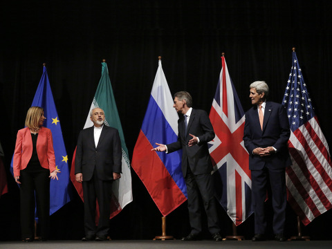 'British Foreign Secretary Philip Hammond, 2nd right, U.S. Secretary of State John Kerry, right, and European Union High Representative for Foreign Affairs and Security Policy Federica Mogherini, left, talk to Iranian Foreign Minister Mohammad Javad Zarif as the wait for Russian Foreign Minister Sergey Lavrov, not pictured, for a group picture at the Vienna International Center in Vienna, Austria, July 14, 2015 (Credit: AP Photo/Carlos Barria)